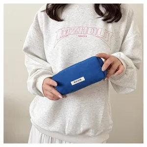 Detailed view of blue canvas pencil pouch minimalist stationery organizer and makeup bag.