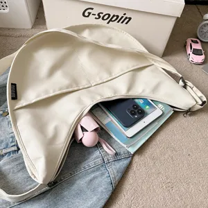 Detail shot of solid color minimalist hobo crossbody dumpling bag showing large capacity space.