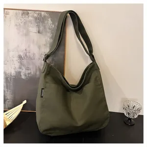 Detailed view of army green canvas shoulder bag showing large capacity and durable strap.