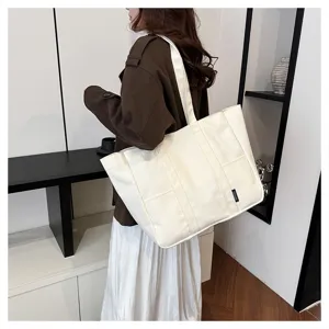 Large capacity white canvas tote bag for women, daily commute shoulder bag with pockets.