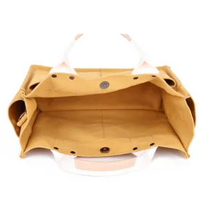 Detailed view of the large capacity canvas tote bag interior, showing structured compartment design.