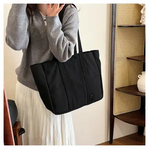 Black canvas tote bag for women, large capacity shoulder bag for daily commuting and school use.