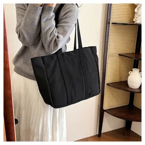 Casual black canvas tote bag large capacity shoulder bag for daily commuting and school use.