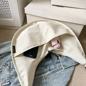 White crescent dumpling shoulder bag detail showing multi-pocket design and large capacity.