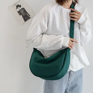 Minimalist dark green nylon crescent shoulder bag for women, casual crossbody daily use.