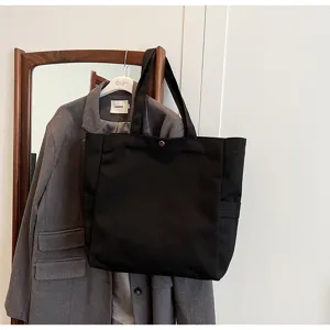 Black canvas tote bag for women, casual shoulder shopping bag for daily commute and school.