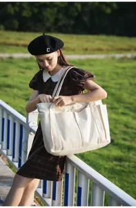 Canvas tote bag detail showcasing large capacity and multiple exterior pockets outdoor scene.