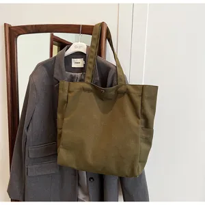 Casual olive green canvas tote bag with side pockets, stylish shoulder bag for daily use.
