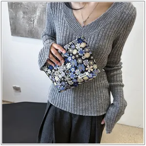 Small floral cosmetic pouch detail shot, portable fabric makeup bag clutch for daily use.