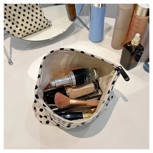 Portable large capacity makeup bag with zipper closure for daily cosmetics storage.