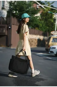 Large capacity black canvas tote bag, versatile shoulder handbag for daily commute.