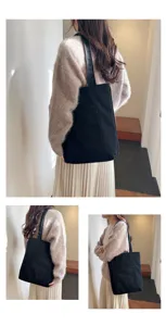 Detailed view of women casual black canvas shoulder bag with front pocket, daily wear outfit scene.