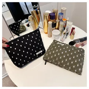 Detailed view of the French style distressed linen cosmetic bag, perfect travel makeup pouch.