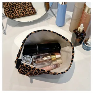 Close-up of leopard print canvas cosmetic bag interior showing large storage capacity.