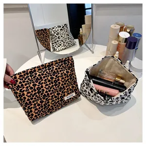 Detailed view of leopard print cosmetic bag with large capacity and portable storage design.