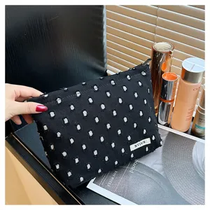 Detailed view of the black linen distressed cosmetic bag, perfect for travel and storage.