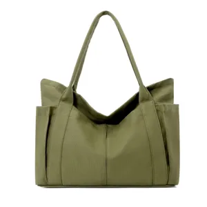 Minimalist green canvas tote bag for women, large capacity daily shoulder handbag with pockets.