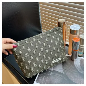 Dark green distressed fabric makeup bag with sparkly rhinestone details and portable design.