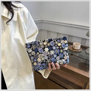 Floral embroidery cosmetic bag detail view, portable makeup pouch for daily use and travel