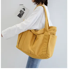 Casual yellow canvas tote bag for women, large capacity shoulder bag with multiple pockets.