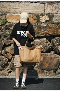 Casual canvas tote bag with multi-pockets, large capacity, stylish everyday shoulder bag.