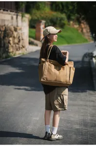 Casual canvas tote bag with large capacity, multiple pockets and stylish design for daily use.