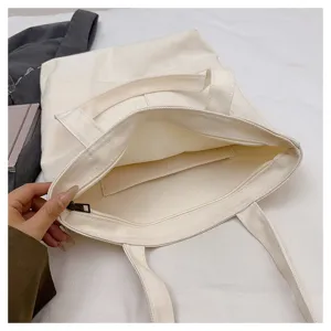 White canvas tote bag with zipper closure and interior pocket for daily use detail view