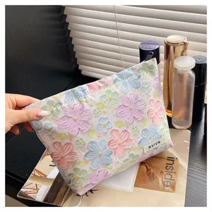 Detailed view of 3D floral cosmetic bag, large capacity makeup pouch for women toiletries storage.