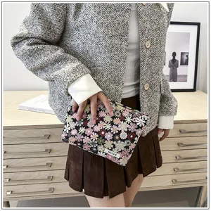 Floral cosmetic pouch detailed shot, compact makeup bag for travel, stylish floral print.