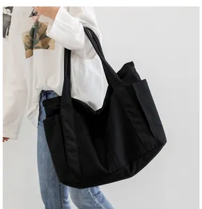 Large capacity black canvas tote bag for women, stylish minimalist shoulder bag for daily use.