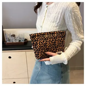 Leopard print cosmetic bag detail shot, portable makeup storage pouch, clutch design.