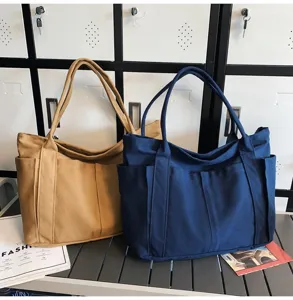 Canvas tote bag with large capacity and multi pockets for daily commute and casual use.