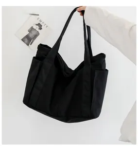Black canvas tote bag for women, large capacity shoulder bag with side pockets, casual daily use.