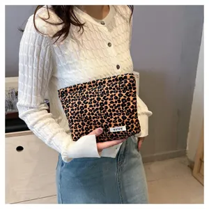 Leopard print cosmetic bag close up view, portable makeup pouch detail showing woven label.