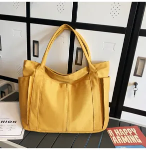 Yellow canvas tote bag with large capacity, multi-pocket casual shoulder bag for women.