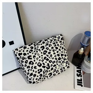 Black and white leopard print cosmetic bag, portable makeup storage pouch with zipper detail.