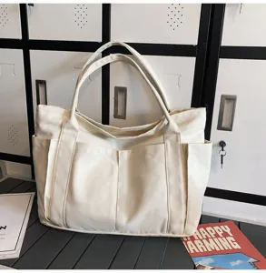 Minimalist canvas tote bag with multiple pockets for women, stylish and spacious daily bag.