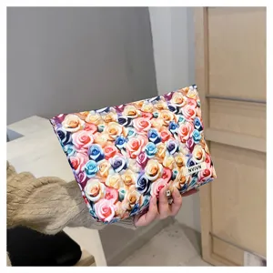 Close-up detail of the colorful rose print makeup bag, showing clear floral pattern and handy size.