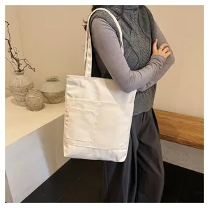 Detailed view of the casual canvas tote bag with multiple pockets for daily student use.