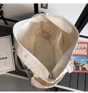 Detailed top view of the large capacity canvas tote bag showing interior structure and pockets.