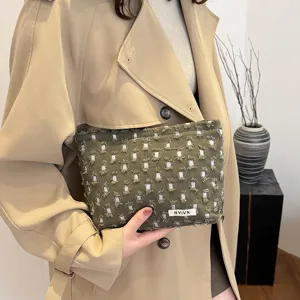 Chic distressed green canvas makeup bag for women, portable travel toiletry storage pouch.