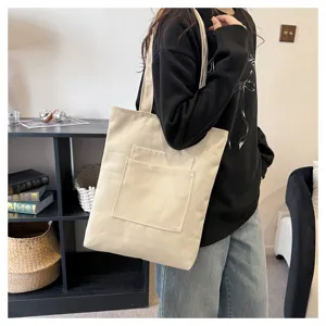 Canvas tote bag detail view, large capacity shoulder bag with front pocket for daily use.