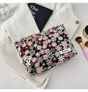 Detailed view of portable floral cosmetic pouch, aesthetic makeup organizer bag for daily use.