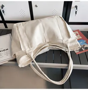 Minimalist beige canvas tote bag for women, large capacity daily shoulder handbag style.