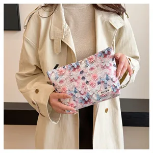 Detailed view of a large capacity cosmetic bag featuring 3D floral and butterfly pattern.