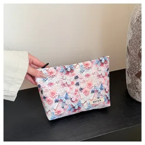 Detailed view of large capacity floral cosmetic bag for women, stylish butterfly print pouch.