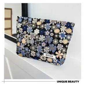 Woven floral cosmetic bag with colorful small flowers pattern, stylish portable makeup pouch.