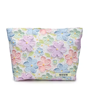Spacious 3D embossed floral cosmetic bag for women, stylish large capacity travel makeup pouch.