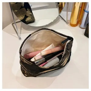 Detail view of the elegant black and gold floral jacquard cosmetic bag showing large capacity.
