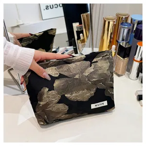 Elegant black gold floral jacquard cosmetic bag, large capacity clutch for daily use.